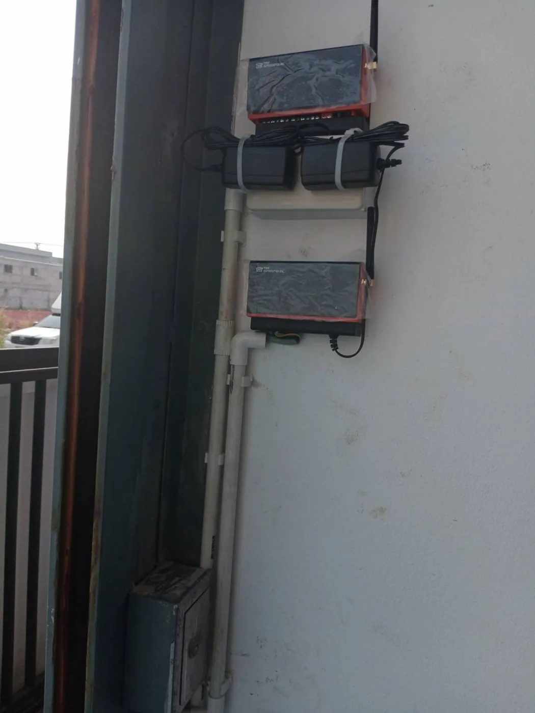 ChowHUB and control box wired on a wall beside a gate